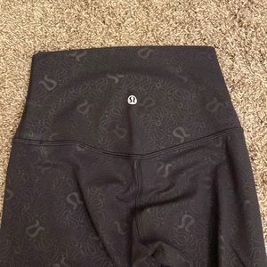 Worn once black lululemon leggings with emblem print! Size 2